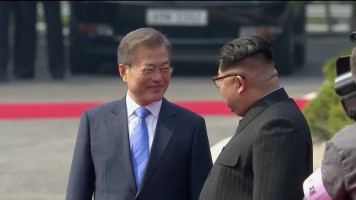 South Korean President Moon Jae-in and North Korean leader Kim Jong Un at a welcome ceremony at the inter-Korean summit at the truce village of Panmunjom, in this still frame taken from video